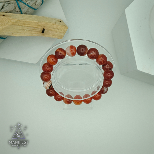 Beaded bracelet on a clear stand with a white background