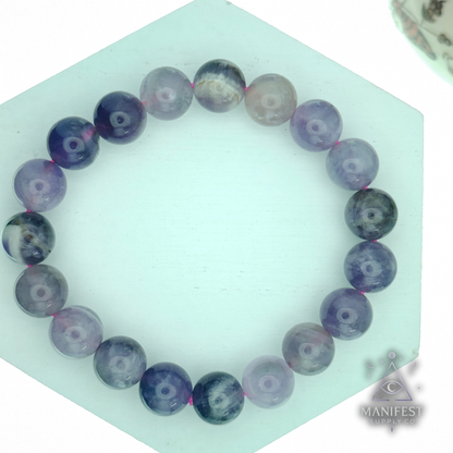 Amethyst on a white surface with 'Manifest Supply Co.' branding.