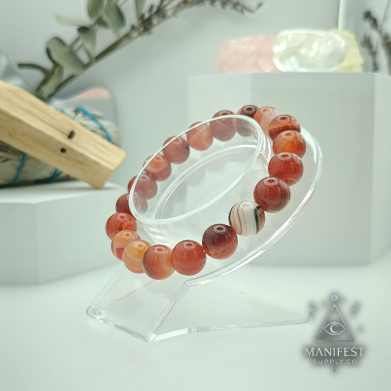 Beaded bracelet on a clear stand with a soft focus background