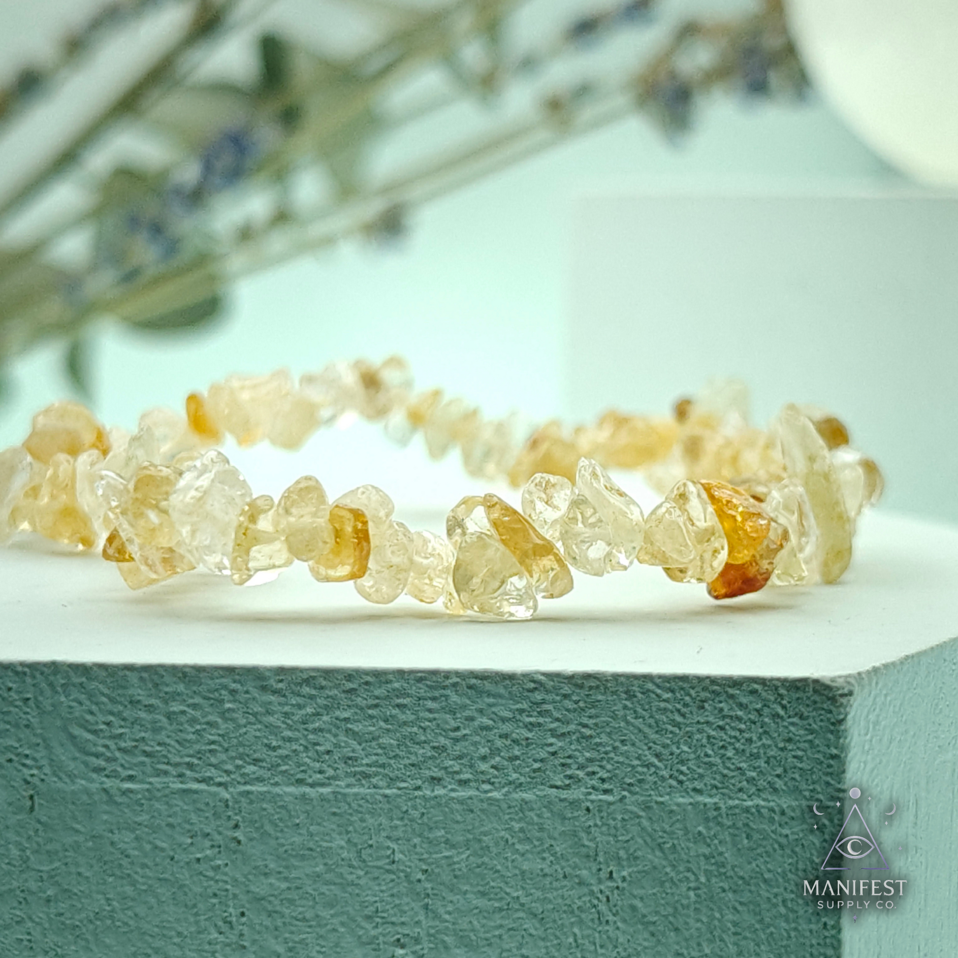 Citrine Chip BraceletCrystal bracelet on a white surface with a blurred natural background