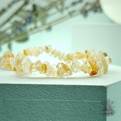 Citrine Chip BraceletCrystal bracelet on a white surface with a blurred natural background