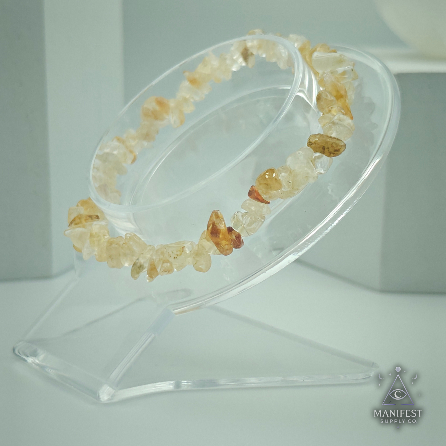Citrine Chip Bracelet-Crystal bracelet on a clear stand with 'Manifest' branding.