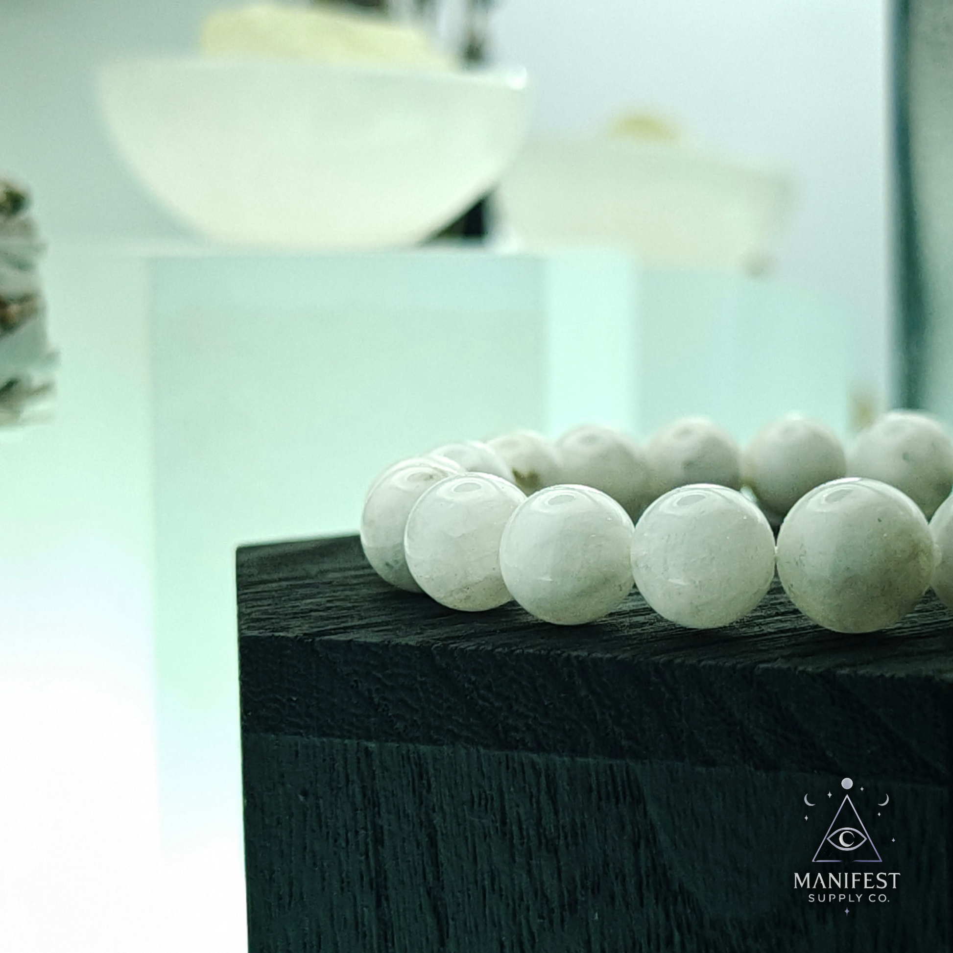 White beaded bracelet on a light green background