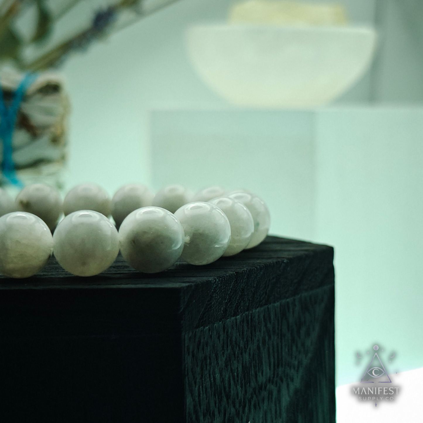 Beaded bracelet on a clear stand with a blurred background