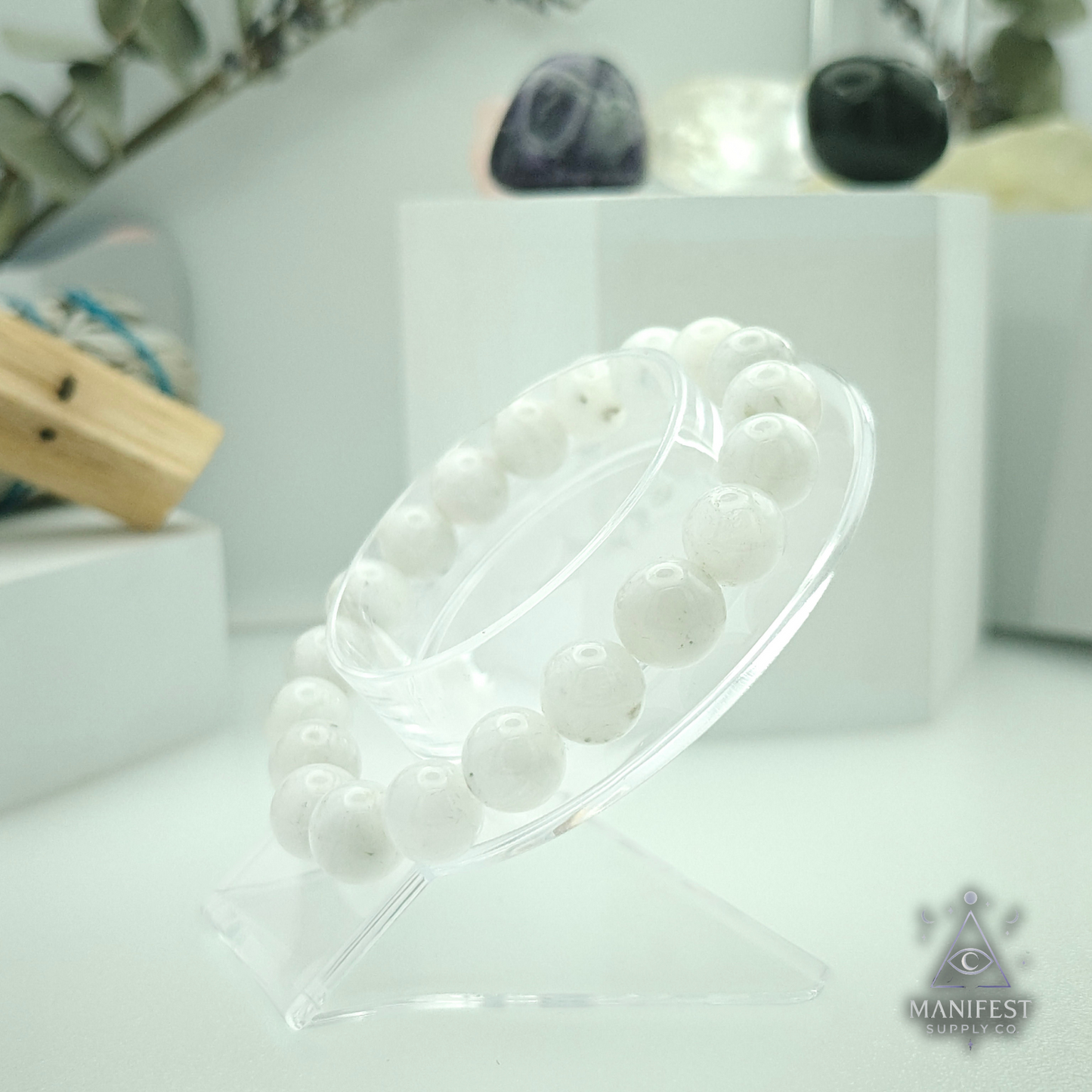 Rainbow Moonstone - 10mm MSWM with white spherical beads on a blurred background