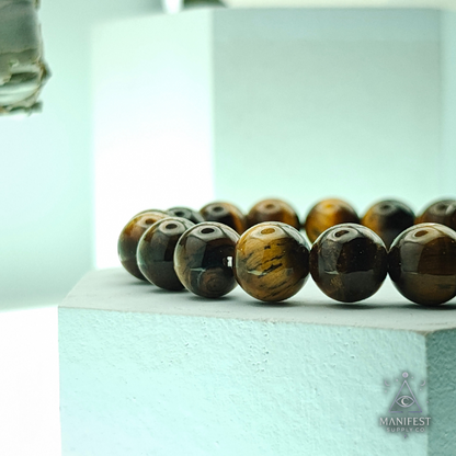 Beaded bracelet with tiger eye beads on a light blue background