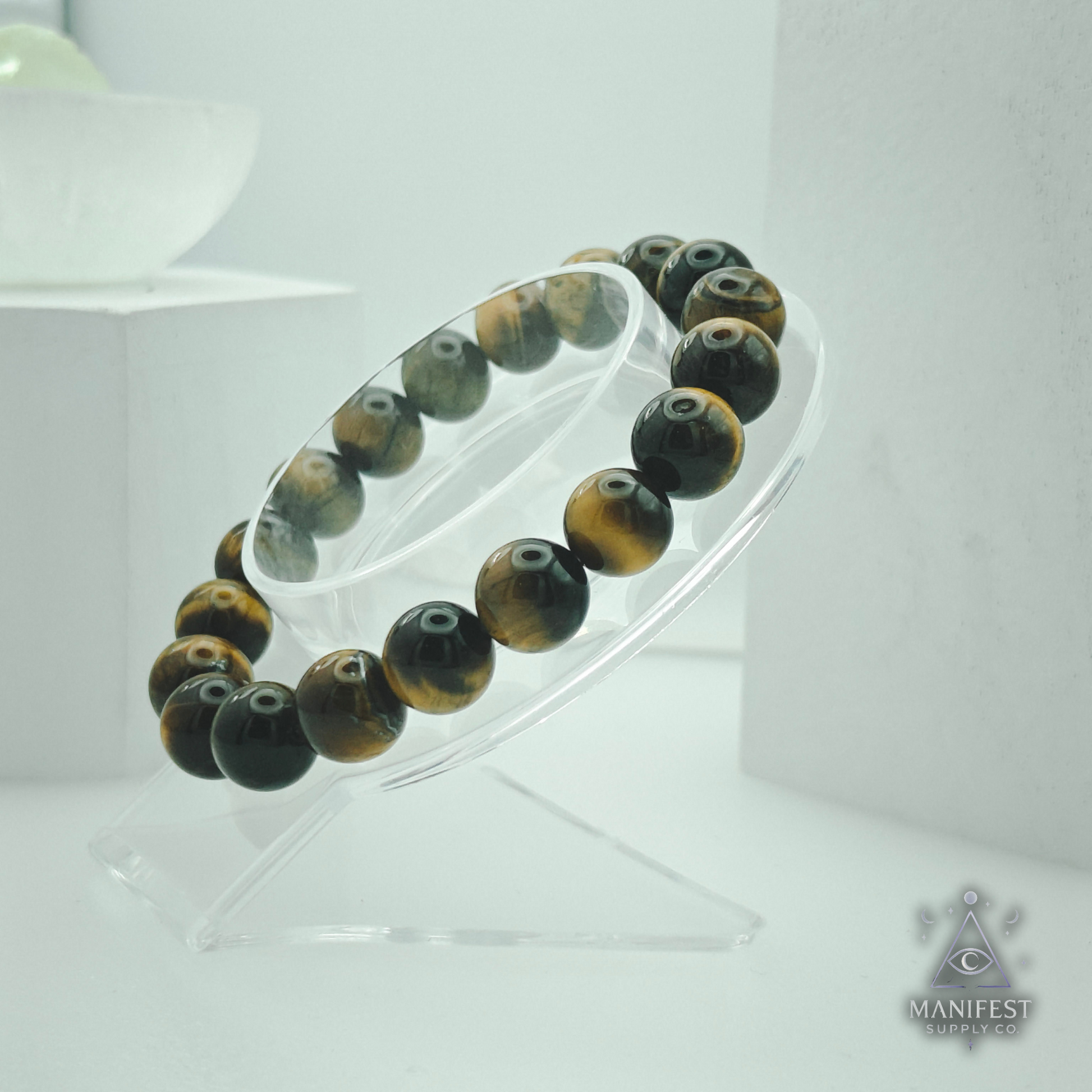 Beaded bracelet on a clear stand withManifest brand logo.